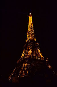 Illuminated tower against sky at night