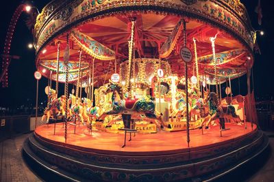 Close-up of illuminated carousel at amusement park