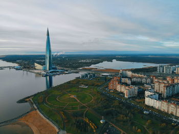 High angle view of buildings against cloudy sky