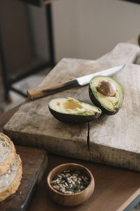 Fresh avocado on cutting board in kitchen at home