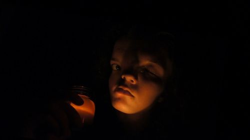 Portrait of young woman in darkroom