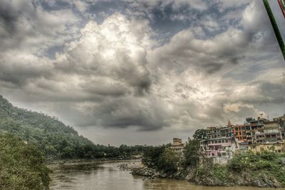 Buildings against cloudy sky