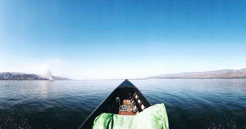 Scenic view of lake against clear blue sky