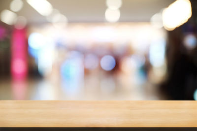 Defocused image of illuminated lights on table