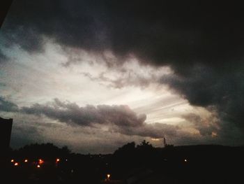 Low angle view of storm clouds over city