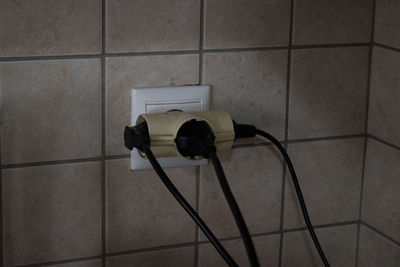 Close-up of electric lamp on wall