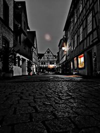 Surface level of street amidst buildings at night