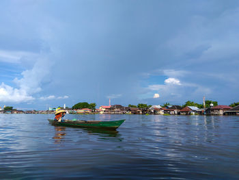 Boats moored on sea against sky