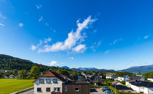 Wooden buildings with scandinavian mountain range view in port town alesund, sunnmore district.