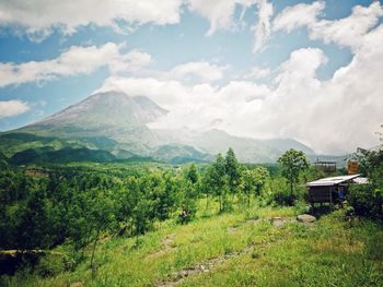 Scenic view of mountains against cloudy sky