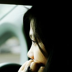 Close-up of serious young woman looking away