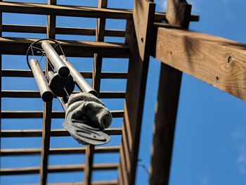 Low angle view of metal structure against blue sky