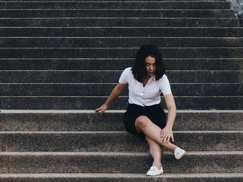 Woman sitting on staircase