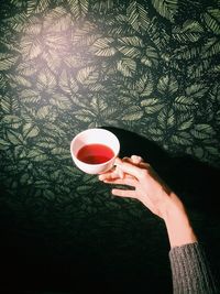 Close-up of hand holding coffee cup