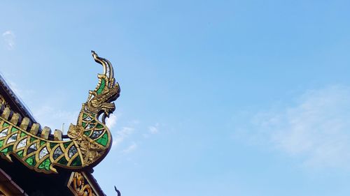 Low angle view of statue against blue sky