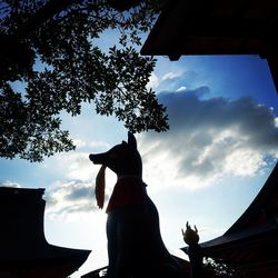 Low angle view of silhouette trees against sky