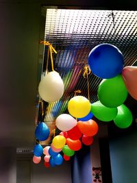 Low angle view of balloons hanging on ceiling at home