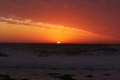 Scenic view of sea against romantic sky at sunset
