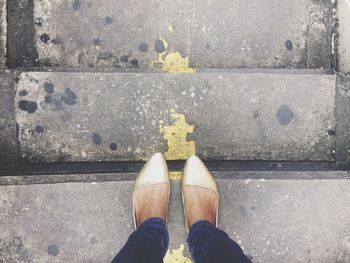 Low section of woman standing on steps