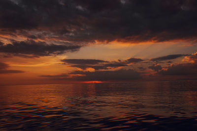 Scenic view of sea against orange sky