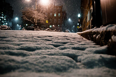Surface level of snow covered street at night