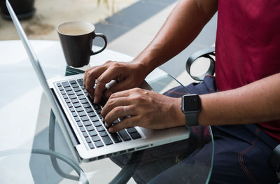 Low angle view of man using laptop on table