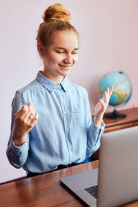 Young woman student having classes, learning online, watching lesson remotely