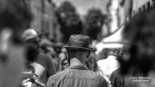 Rear view of people dancing on street in city