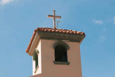 Low angle view of bell tower against sky