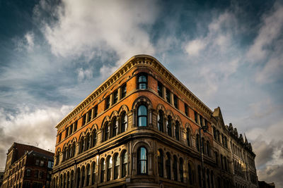 Low angle view of building against cloudy sky