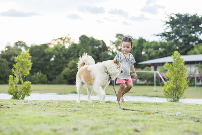 Side view of dog running on field