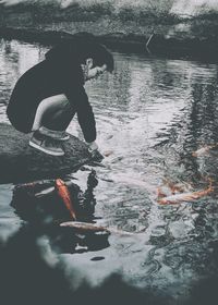 Side view of man swimming in lake