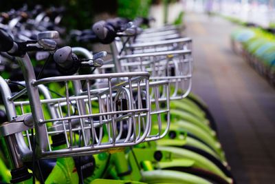 Bicycles with metal baskets parked on footpath