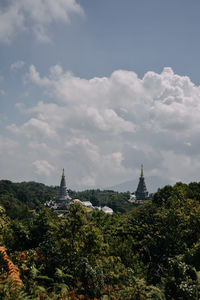 View of trees and building against sky