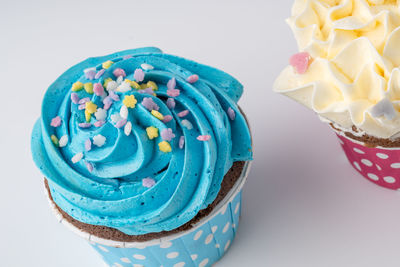 Close-up of cupcakes on table against white background