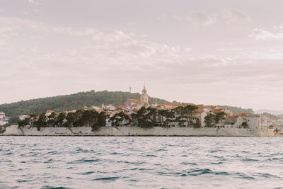 Scenic view of sea and buildings against sky