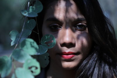 Close-up portrait of woman with leaves