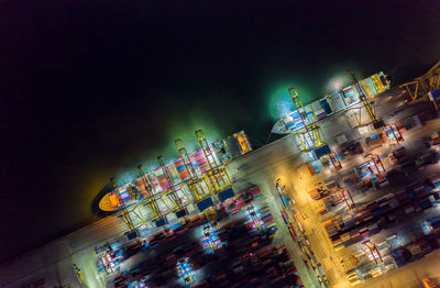 High angle view of illuminated buildings against sky at night