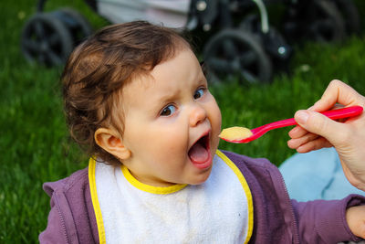 Close-up portrait of cute boy eating