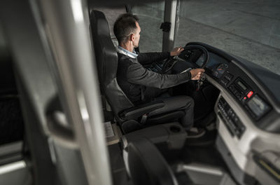 Side view of man sitting in bus