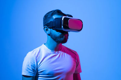 Low angle view of man standing against blue background