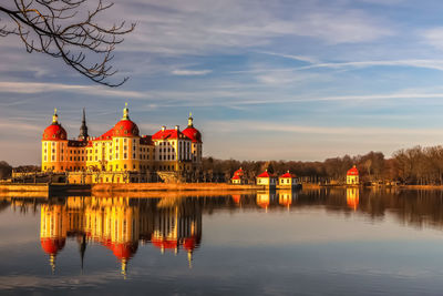 Reflection of building in river during sunset