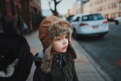 Portrait of young woman in car on street in city