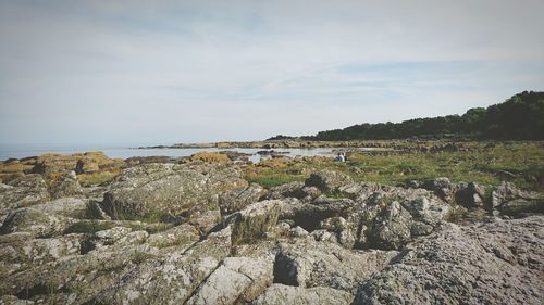 View of rocky beach against the sky