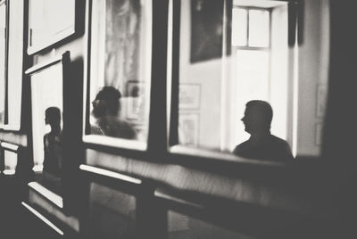 Reflection of people on picture frames