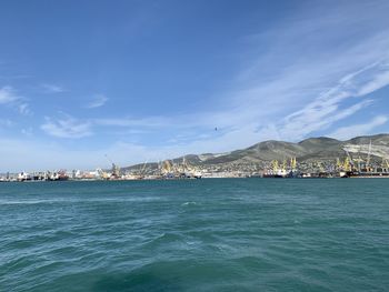 Scenic view of sea by buildings against sky