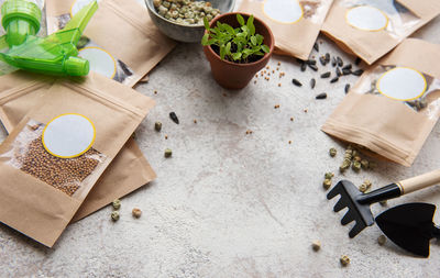 Microgreen seeds in paper bags and microgreen sowing equipment on the table. healthy food.