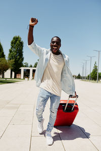 Portrait of young man standing against clear sky