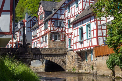 River elz with old bridge and half-timbered houses in monreal, germany