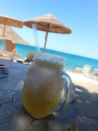 Close-up of drink on table at beach